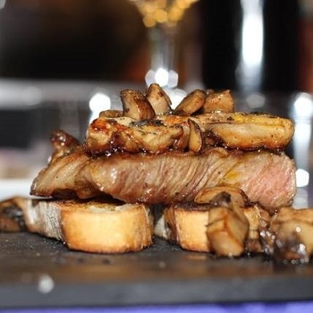 Grilled iberian pork with mushrooms and foie marbella cooking