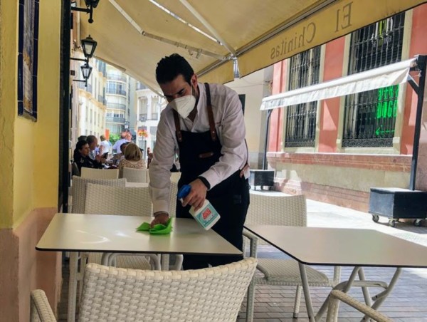 waiter disinfecting of high-contact surfaces malaga tours